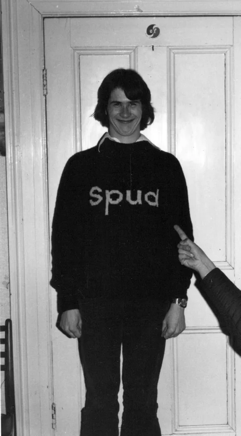 A teenager in a jumper with the word Spud on it