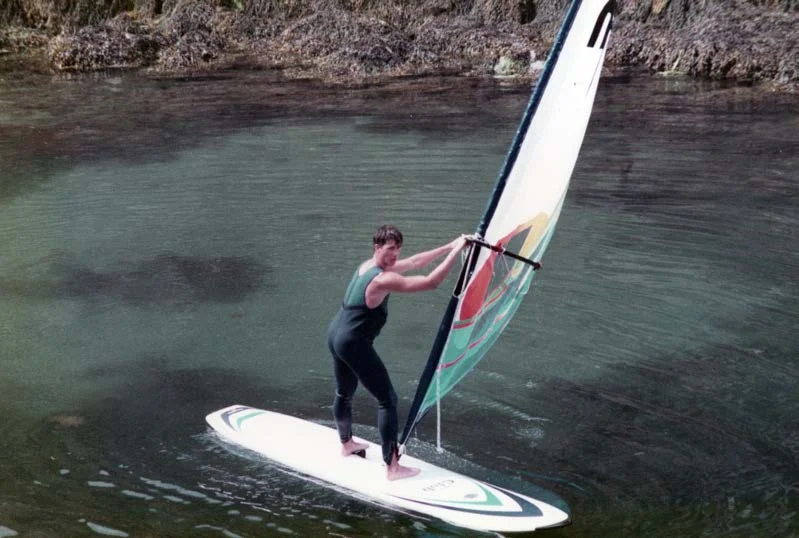 A windsurfer on clear water