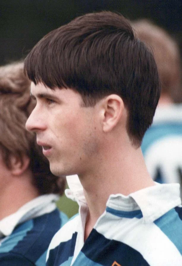 A young man in a rugby shirt seen in profile