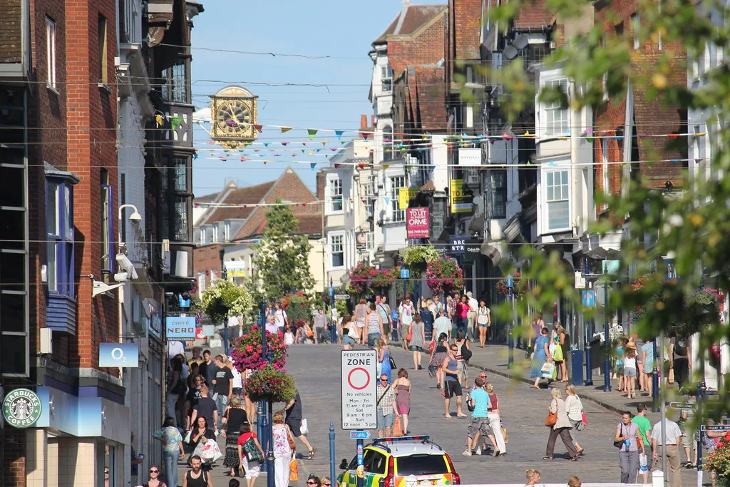 Guildford High Street on a summer Saturday, with the Guildhall clock over the street